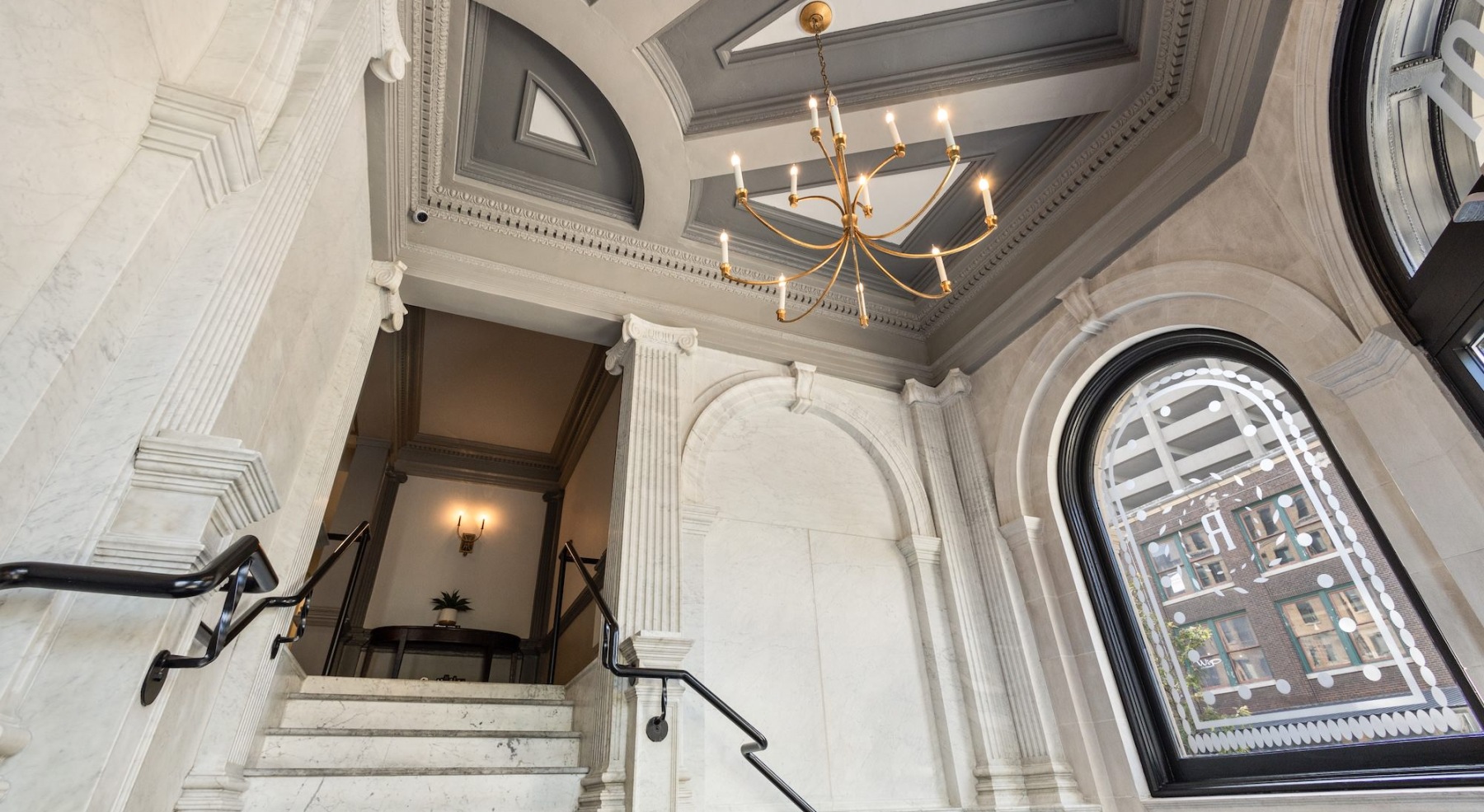 an ornate stairway and large windows