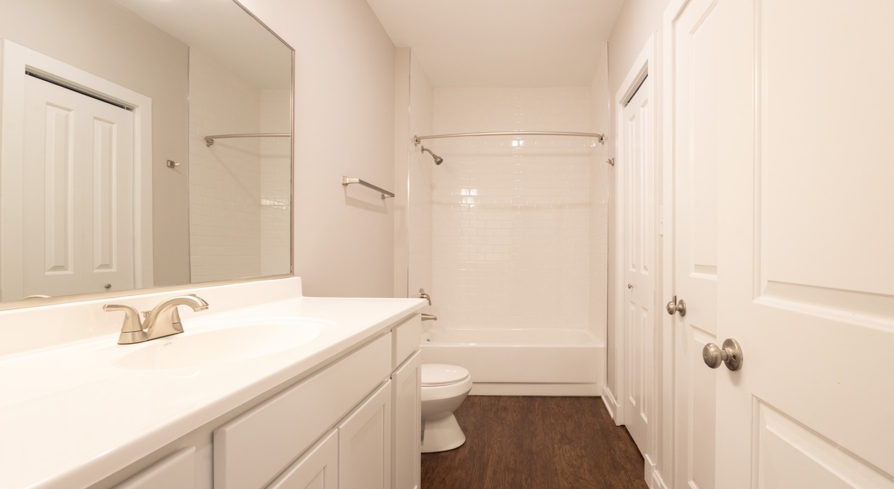 a spacious bathroom with a vanity and a large mirror