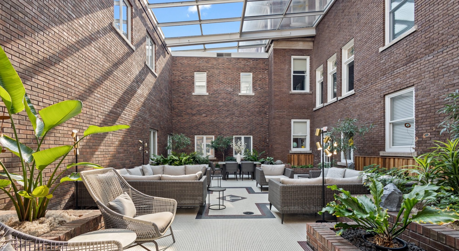 a spacious courtyard with tables, chairs and plants