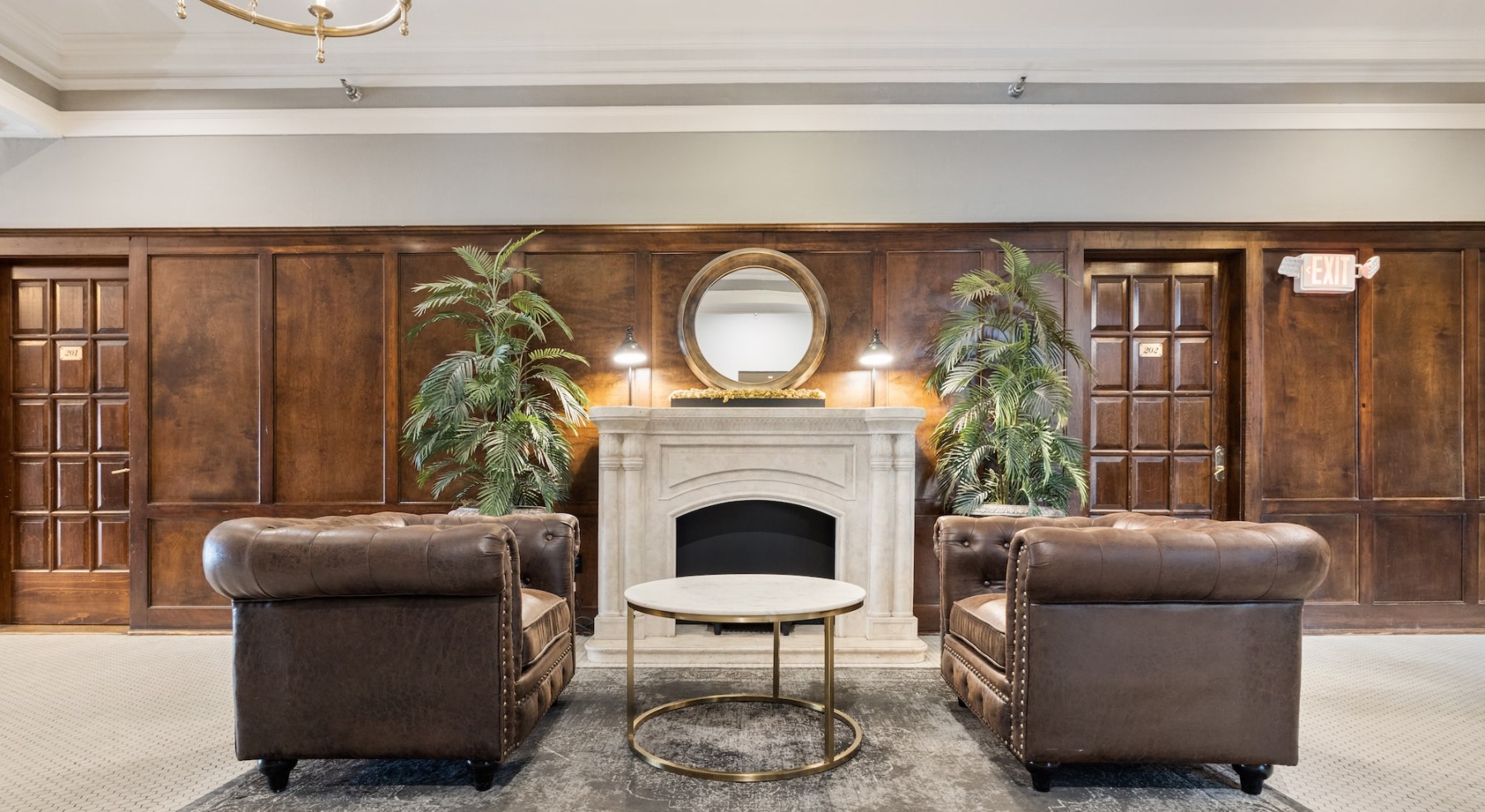 a spacious room with a fireplace and large chairs