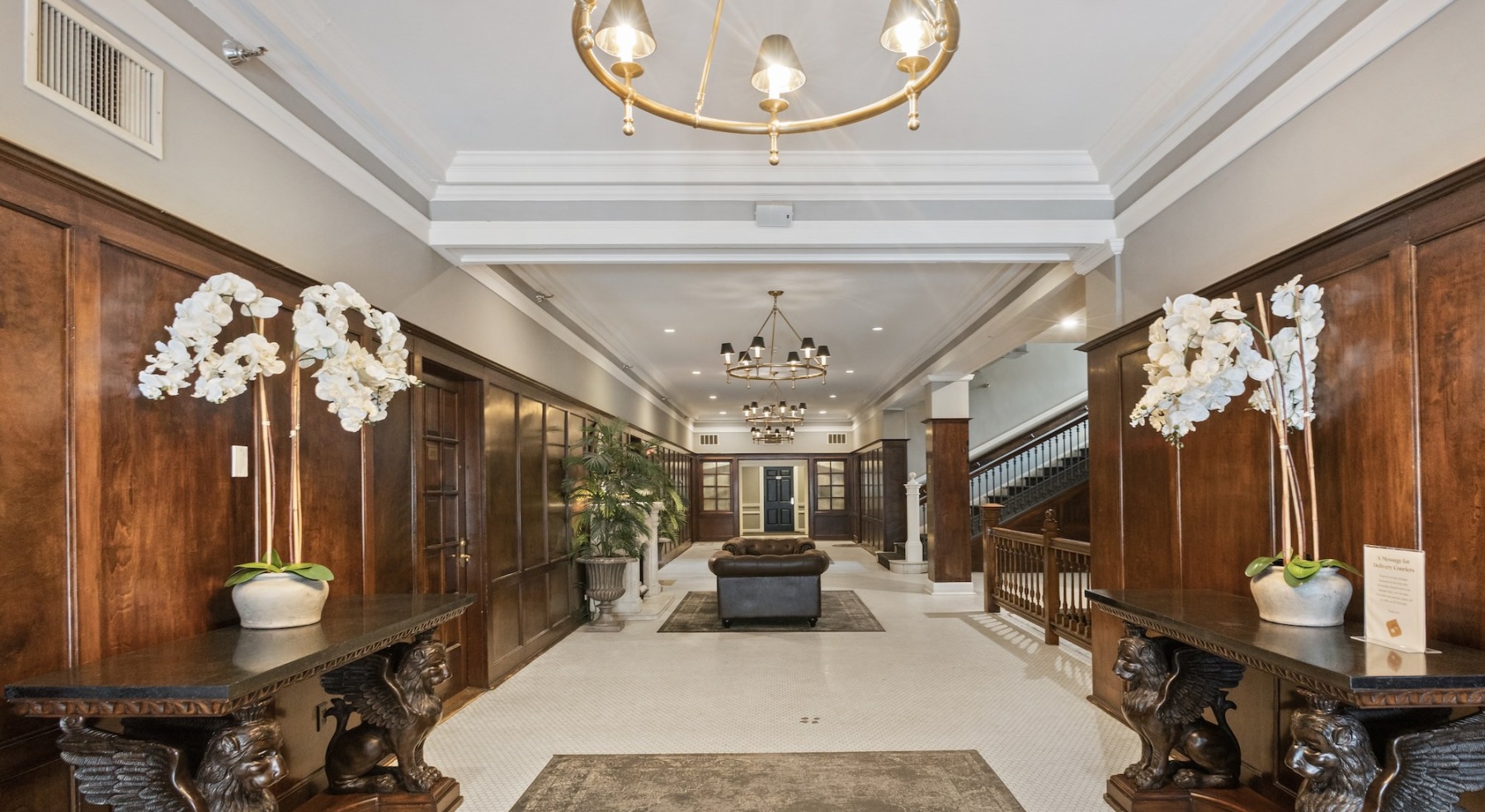 a spaciosu ornate hall with tiled floors and a chandelier