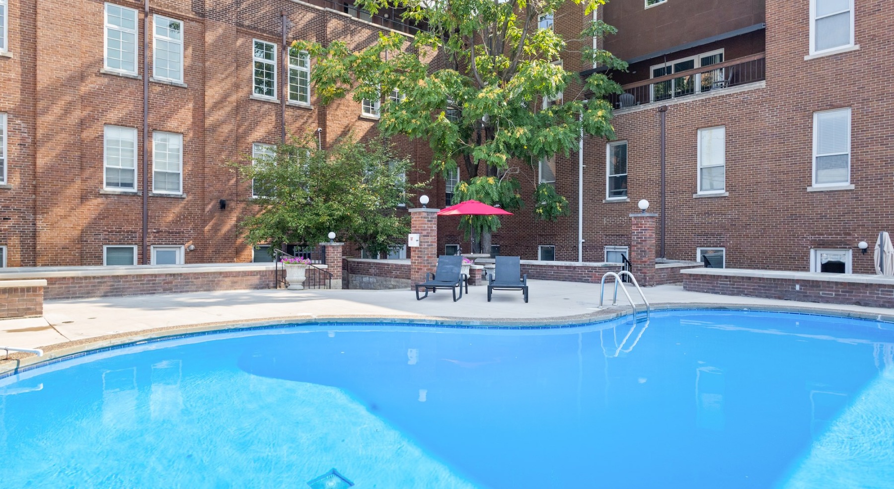Resort-style swimming pool with lounge seating