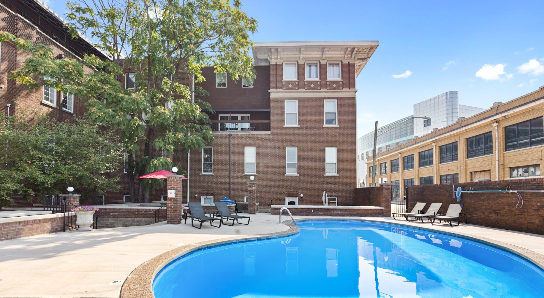 Resort-style swimming pool with lounge seating