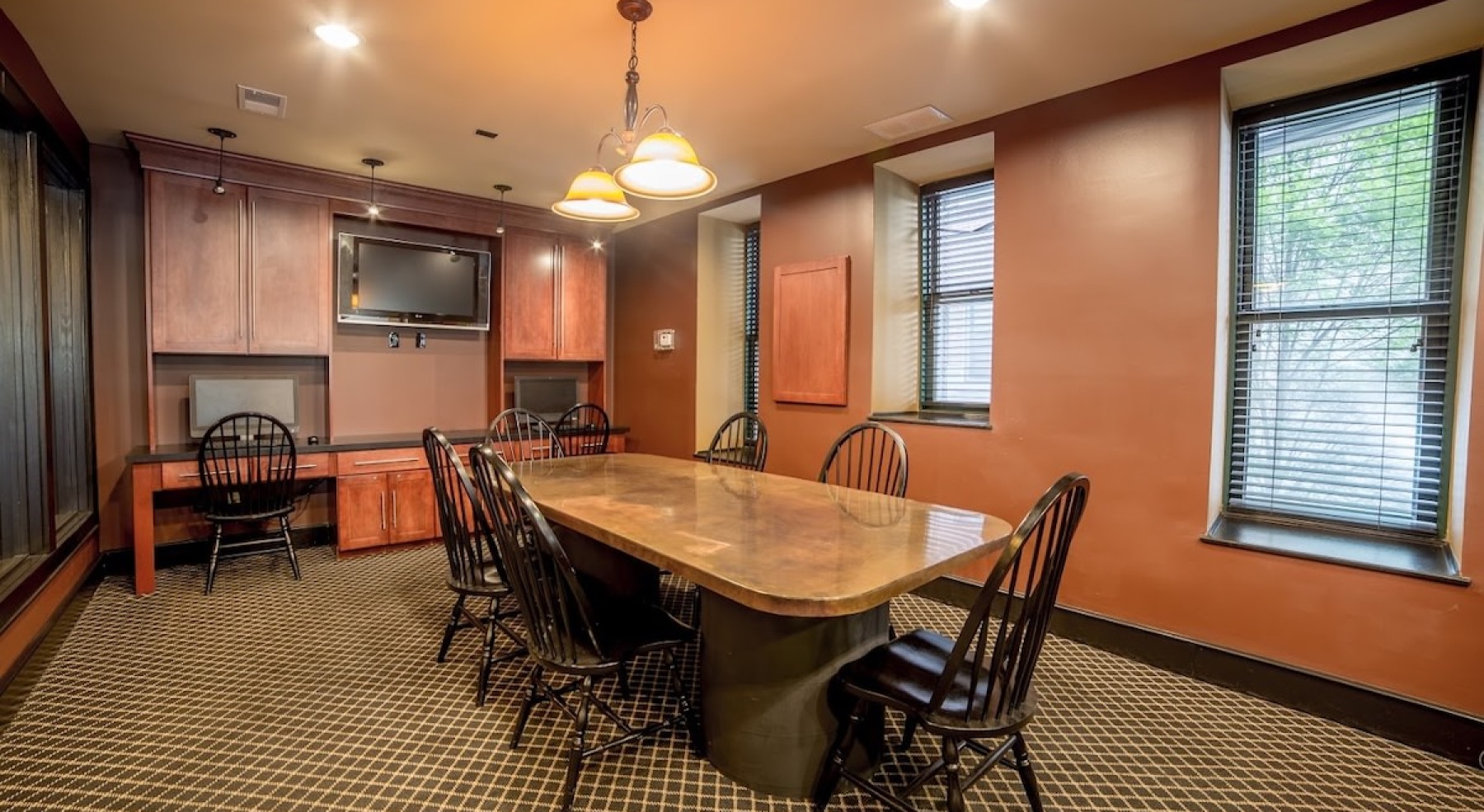 a large room with windows and a large table
