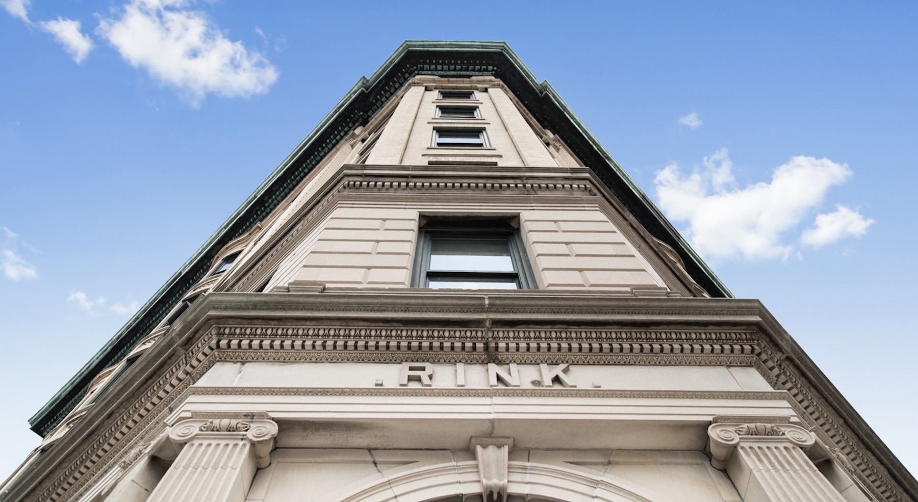 a large building from street view looking towards the sky