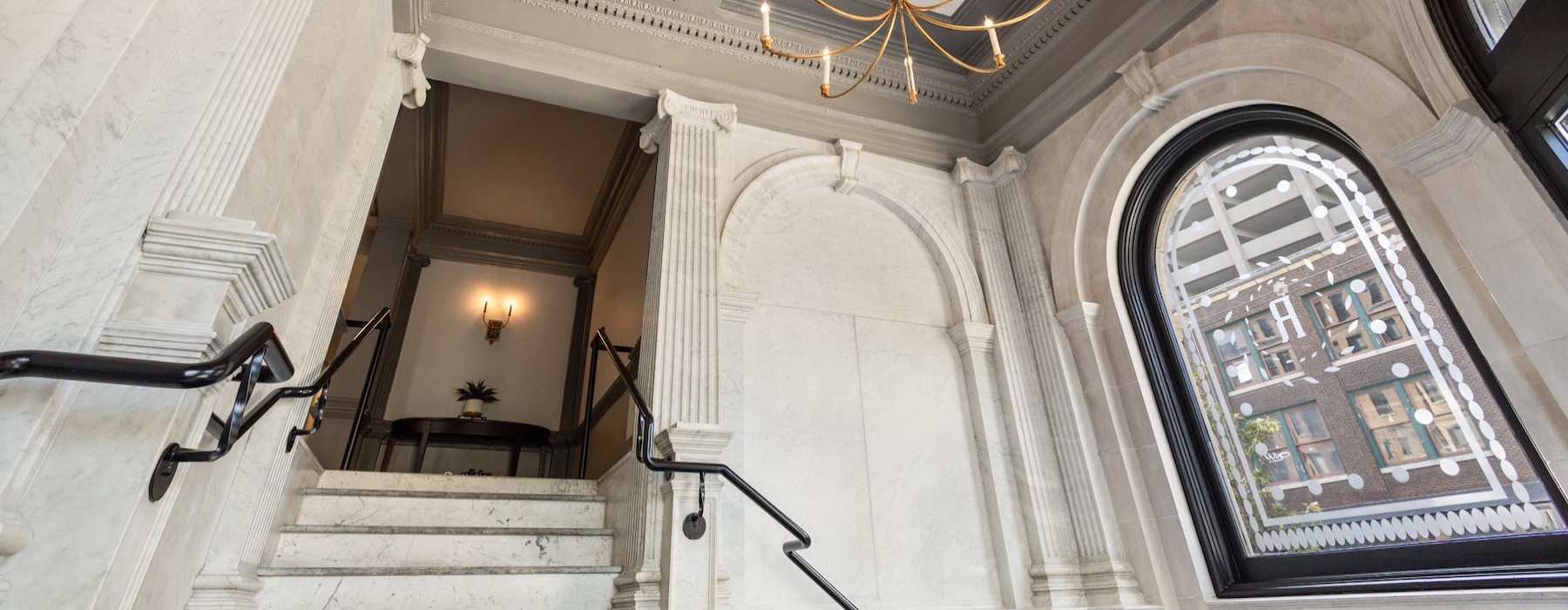 an ornate staircase with large windows